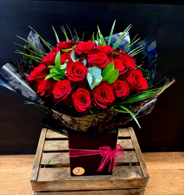 24 best red roses hand tied in water bouquet