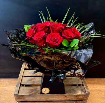 Standard dozen red rose hand tied in water bouquet